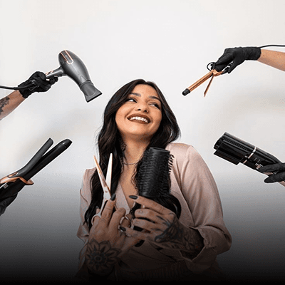 Smiling woman surrounded by hairstyling tools